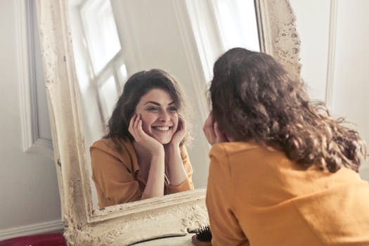 lady looking at herself in the mirror with a smile on her face. The title of the blog is to be encouraged meditation. This blog was written to give others encouragement when they are going through difficult situations