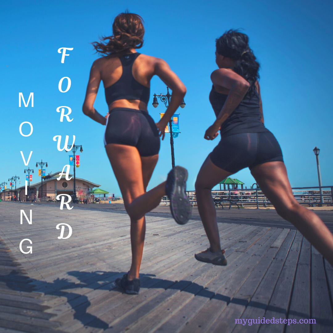 Two women running a race. This picture is geared to encourage others to move forward in their purpose.